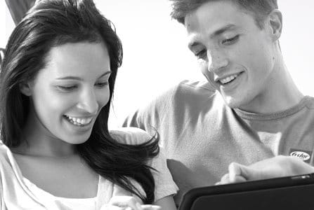 Couple on a couch checking on a tablet
