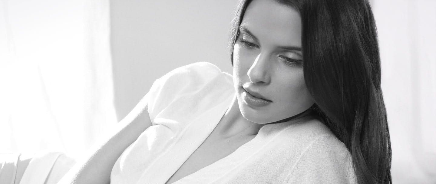 Woman with dark hair in a relaxed pose