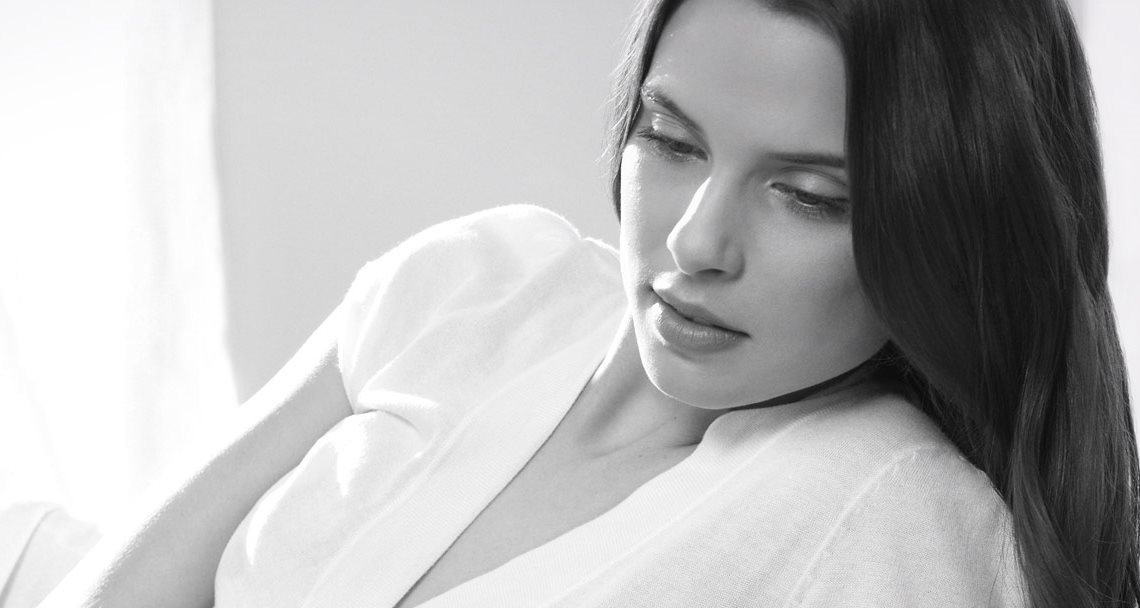 Woman with dark hair in a relaxed pose