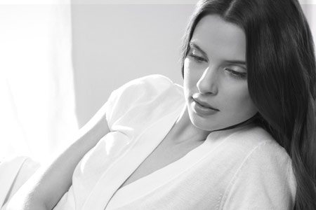 Woman with dark hair in a relaxed pose