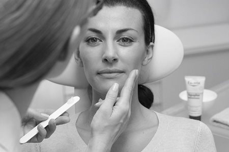 Woman´s face gets treated with Eucerin product