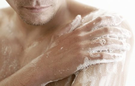 Man washing his body with soap