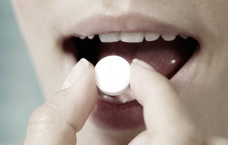 Woman eating pill