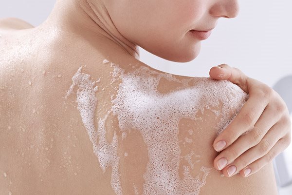 Woman using cleanser on her face