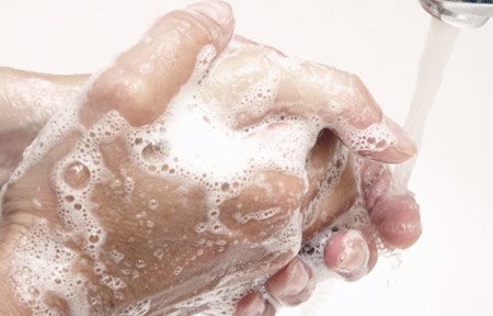 Hands being washed with soap