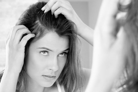 A woman checking for dandruff